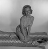 Mid adult woman in bikini sitting on blanket Poster Print - Item # VARSAL255418002