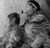 Mature Eskimo man smoking a pipe with his daughter Poster Print - Item # VARSAL990118187