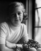Portrait of girl sitting by window with plate of fruits Poster Print - Item # VARSAL25514369