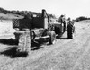 Farmer sitting on a tractor pulling hay baler in a field Poster Print - Item # VARSAL25530532