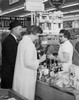 Mature couple standing at the checkout counter in a store Poster Print - Item # VARSAL2555202