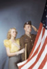 Young man saluting an American flag with a young woman standing beside him Poster Print - Item # VARSAL38074987