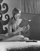 Teenage girl sitting on the bed and reading a book Poster Print - Item # VARSAL25517541