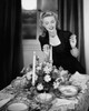 Young woman lighting candle at dining table Poster Print - Item # VARSAL25527181B