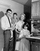 Portrait of parents and their children standing in a kitchen Poster Print - Item # VARSAL25542723