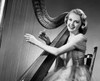 Young woman playing a harp and smiling Poster Print - Item # VARSAL2553364D