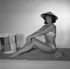 Mid adult woman wearing bikini sitting on towel Poster Print - Item # VARSAL255418007