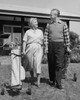 Senior couple walking with golf clubs on golf course Poster Print - Item # VARSAL25548892