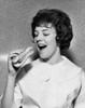 Close-up of a young woman eating a hot dog Poster Print - Item # VARSAL25512644