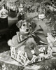 Close-up of a puppy sitting on a stack of Christmas presents Poster Print - Item # VARSAL25514711