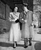Young couple walking on a sidewalk Poster Print - Item # VARSAL2555053B
