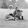 Student couple sitting on grass with open books Poster Print - Item # VARSAL255417672
