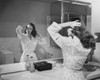 Reflection of young woman brushing her hair in mirror Poster Print - Item # VARSAL25542561
