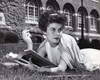 Young woman lying on the grass and holding a book Poster Print - Item # VARSAL25512566