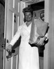 Woman with grocery bag in doorway Poster Print - Item # VARSAL25549231