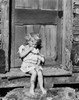 Girl sitting on a doorstep and eating bread Poster Print - Item # VARSAL2553763B