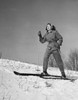 Low angle view of a young woman skiing on snow Poster Print - Item # VARSAL25522943