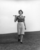 Mid adult woman walking on a golf course with a golf club Poster Print - Item # VARSAL25515631B