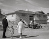 Rear view of couple and their daughter looking at nearly completed house Poster Print - Item # VARSAL25547741