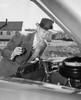 Mature man examining the engine of his car Poster Print - Item # VARSAL25524886