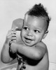 Close-up of a baby holding a telephone receiver Poster Print - Item # VARSAL2559914