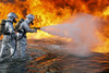 July 30, 2010 - An aircraft rescue firefighting team with the U.S. Marine Corps, attempts to spray out a fuel fire during training. The heat from the flames can reach 1,300 degrees Poster Print - Item # VARPSTSTK103856M