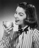 Close-up of a young woman eating a pear Poster Print - Item # VARSAL2553431