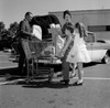 Parents and kids loading shopping bags into car trunk Poster Print - Item # VARSAL255417557