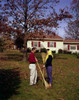 Young couple raking leaves in backyard Poster Print - Item # VARSAL255422644