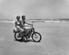 Young couple riding motorcycle on beach Poster Print - Item # VARSAL25522869