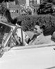 Man sitting in convertible car and reading newspaper Poster Print - Item # VARSAL255416539
