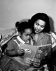 Mother reading book to young daughter Poster Print - Item # VARSAL255424293