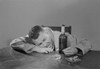 Drunk man sitting behind table Poster Print