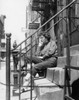 Woman sitting on front stoop Poster Print - Item # VARSAL25549585