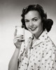 Portrait of young woman holding glass of milk Poster Print - Item # VARSAL2552918
