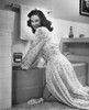 Portrait of a young woman bending over a bathtub in the bathroom Poster Print - Item # VARSAL25542559