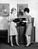 Side profile of two teenage girls looking at a record Poster Print - Item # VARSAL2553491