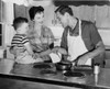 Father preparing food with his wife and son standing beside him in the kitchen Poster Print - Item # VARSAL2552300