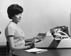 Businesswoman typing on a typewriter in an office Poster Print - Item # VARSAL25548436