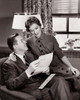 Young couple sitting together in a living room Poster Print - Item # VARSAL25518609