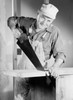 Mature carpenter sawing plank Poster Print - Item # VARSAL255418604