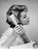 Close-up of a young woman brushing her hair Poster Print - Item # VARSAL25542517