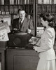 Salesman showing a record to a young woman Poster Print - Item # VARSAL2551251