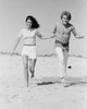Young couple running on beach Poster Print - Item # VARSAL255422432