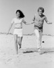 Young couple running on beach Poster Print - Item # VARSAL255422432