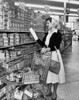 Side profile of young woman reading box in a grocery store Poster Print - Item # VARSAL2551981