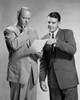 Two businessmen standing discussing document Poster Print - Item # VARSAL25547987