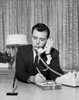 Businessman talking on telephone in office Poster Print - Item # VARSAL25548082
