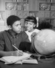Teenage boy and his sister looking at a globe Poster Print - Item # VARSAL25516391