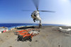 South China Sea, October 27, 2011 - Airmen attach pallet rigs to an SA-330J Puma helicopter abord the forward-deployed amphibious assault ship USS Essex during a replenishment at sea. Poster Print - Item # VARPSTSTK104951M
